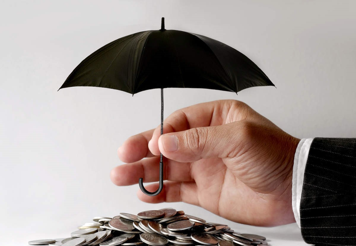 umbrella over pile of coins